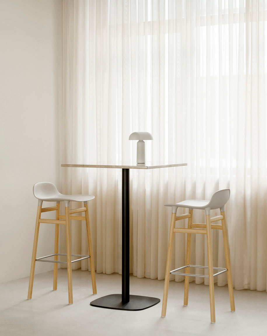 A square cafe table forms wooden top with a black base