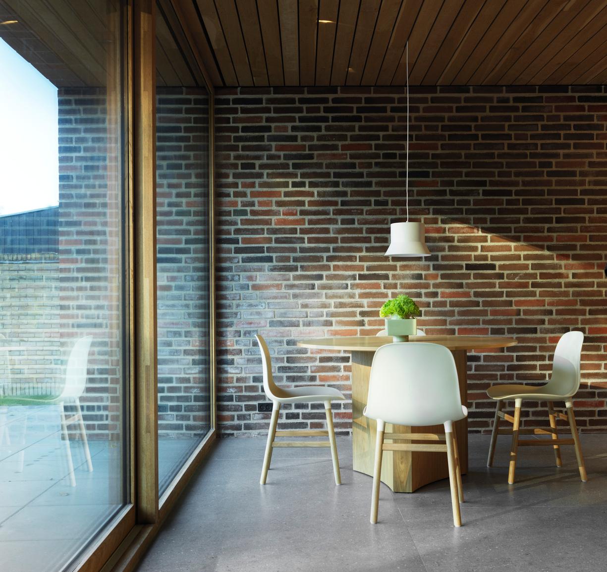 Chair of light gray forms with a nutty base