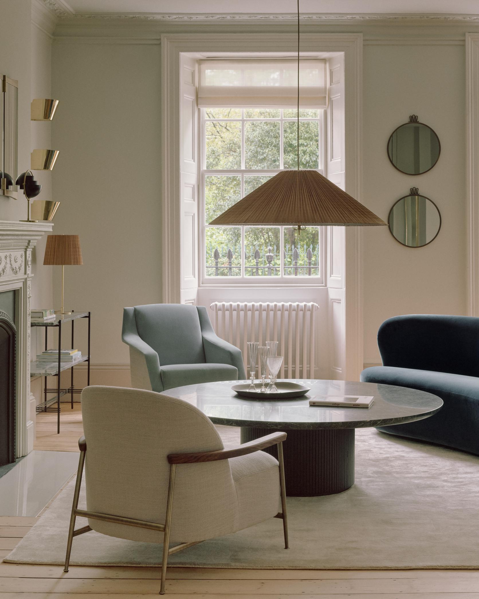 SEJOUR upholstered armchair with a brass base