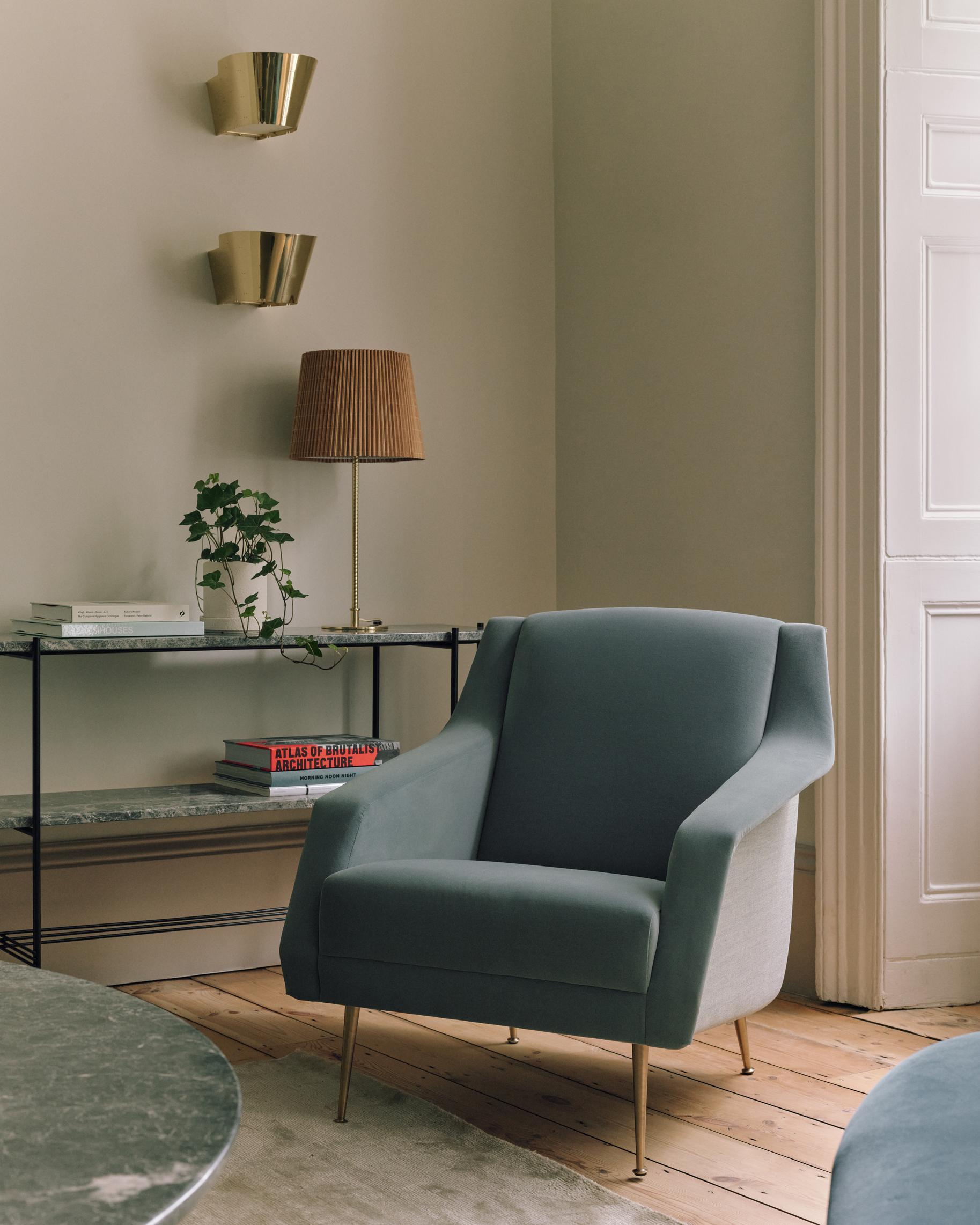 CDC.1 upholstered armchair with a black base