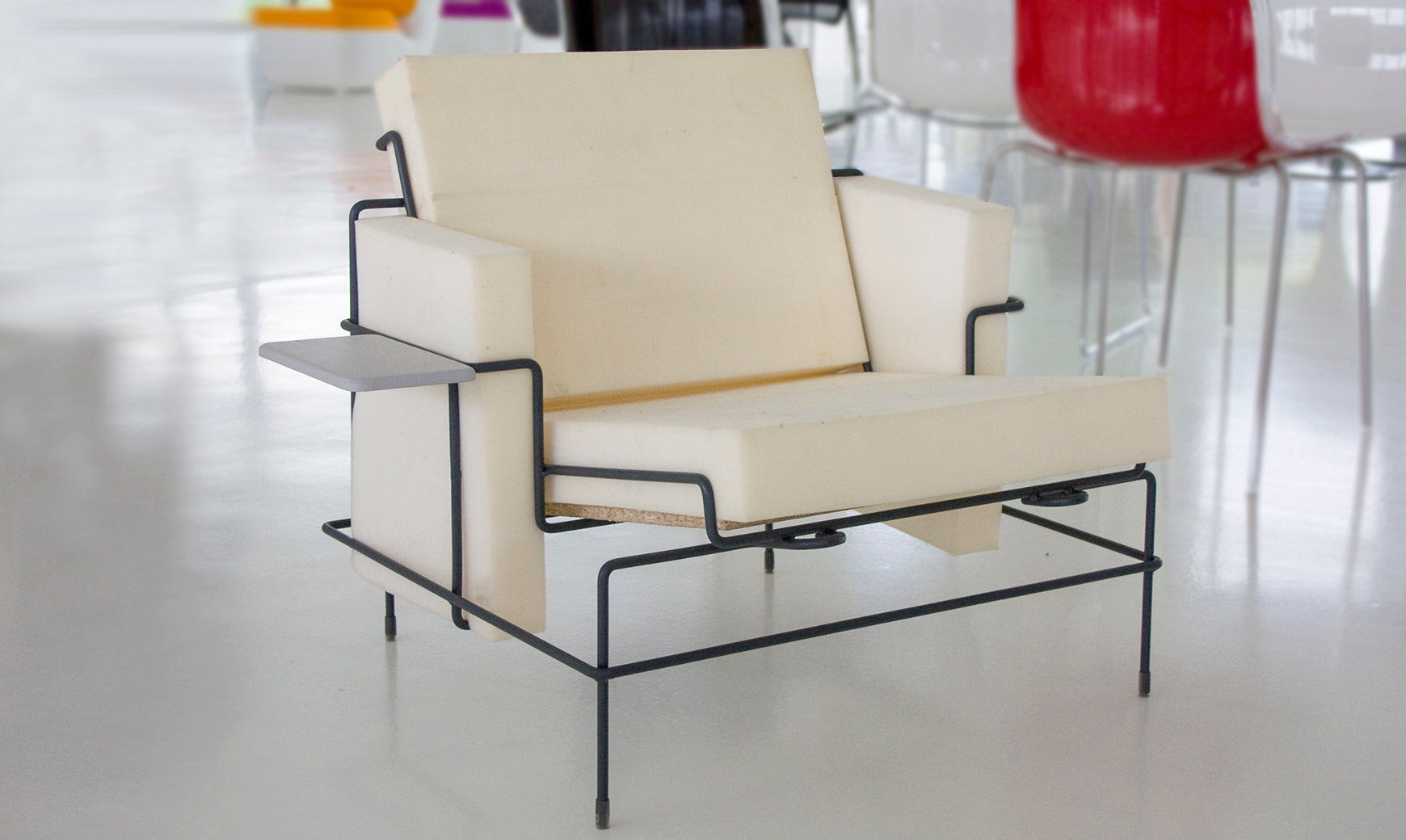 TRAFFIC upholstered armchair with a black steel base