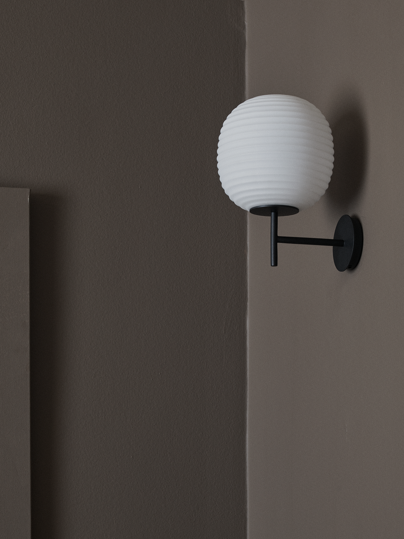 Lantern white wall lamp with a black base