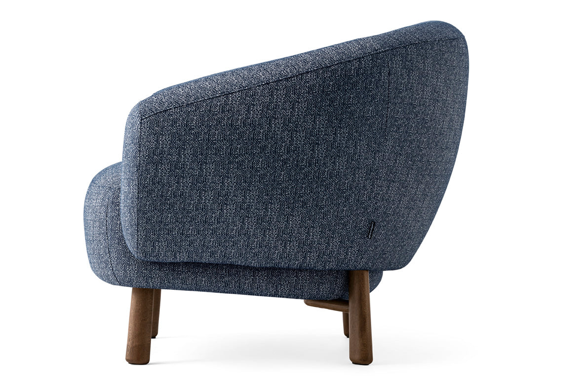 Upholstered RIO armchair with a dark wooden base