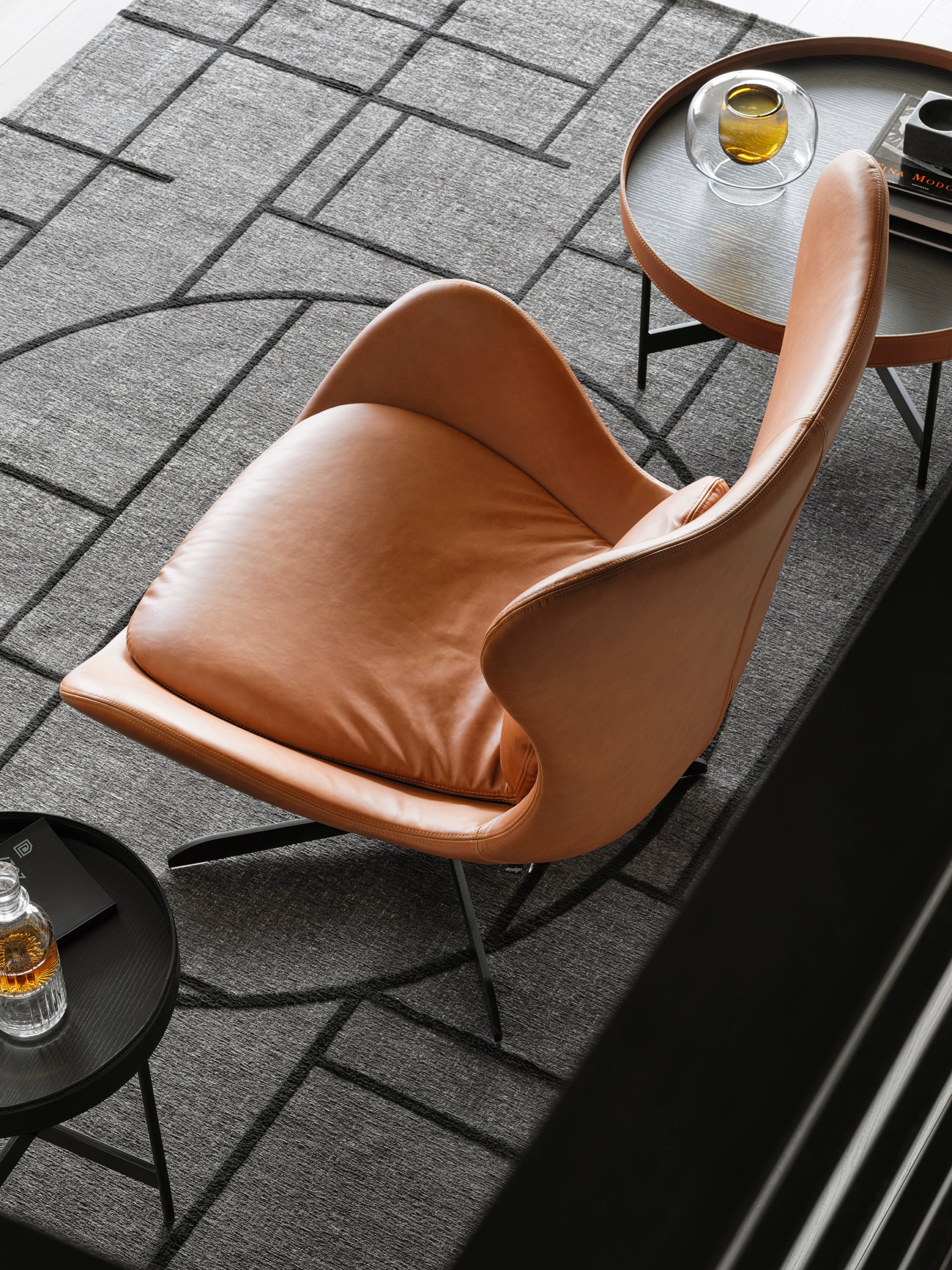 LAZY upholstered swivel armchair with a black metal base