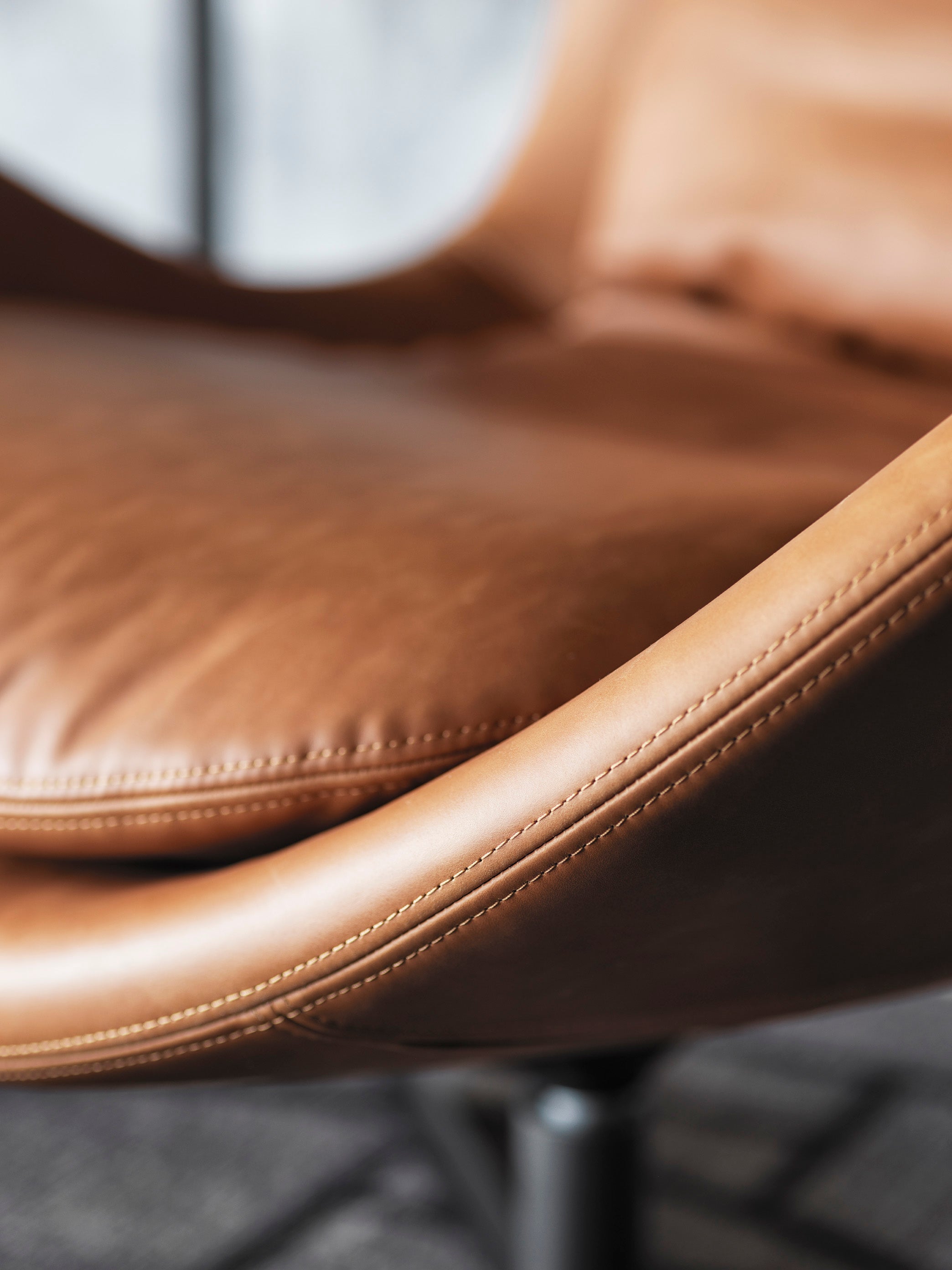 LAZY upholstered swivel armchair with a black metal base