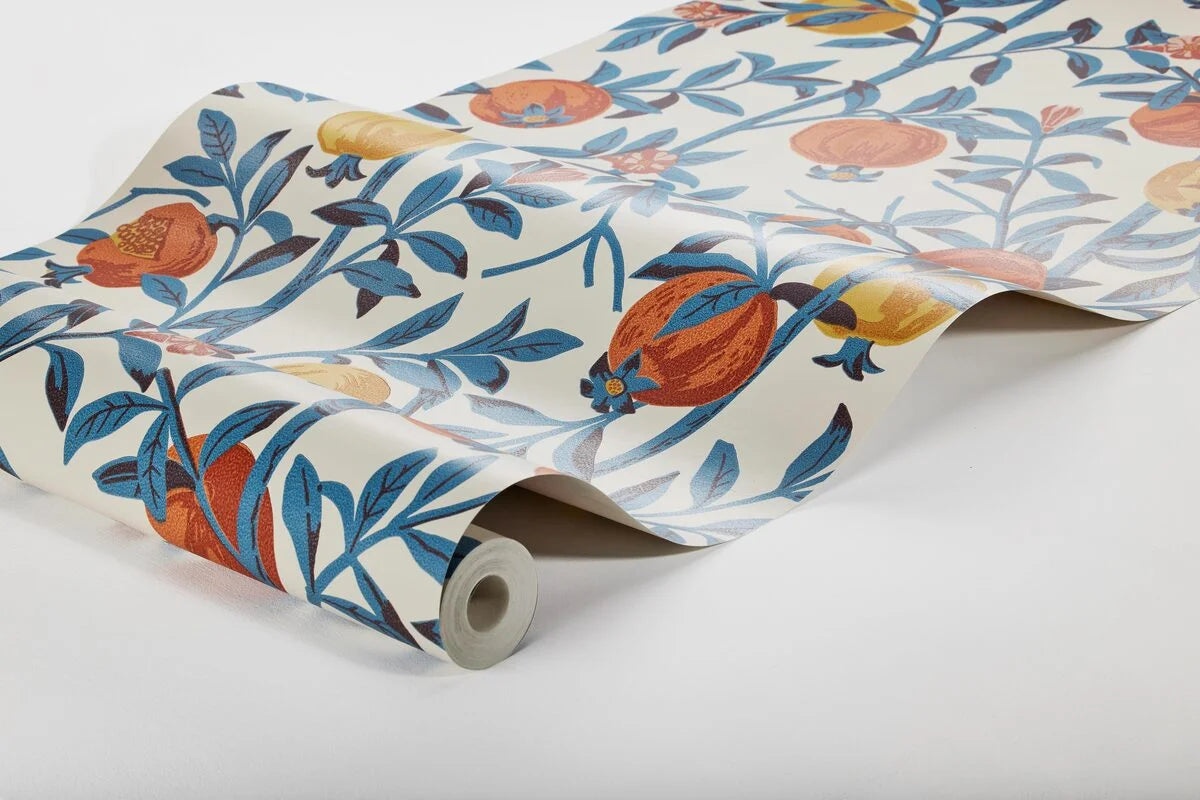 Wallpaper with a botanical pattern of pomegranates in white with blue and orange