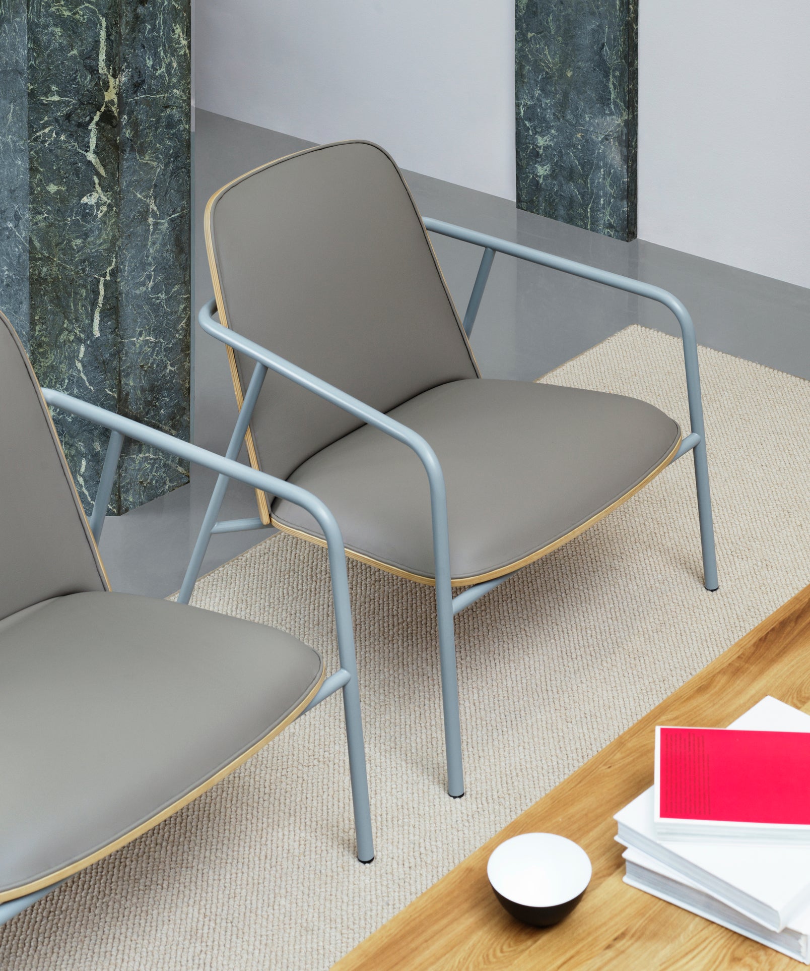 Upholstered armchair pad low black ash veneer with a gray base