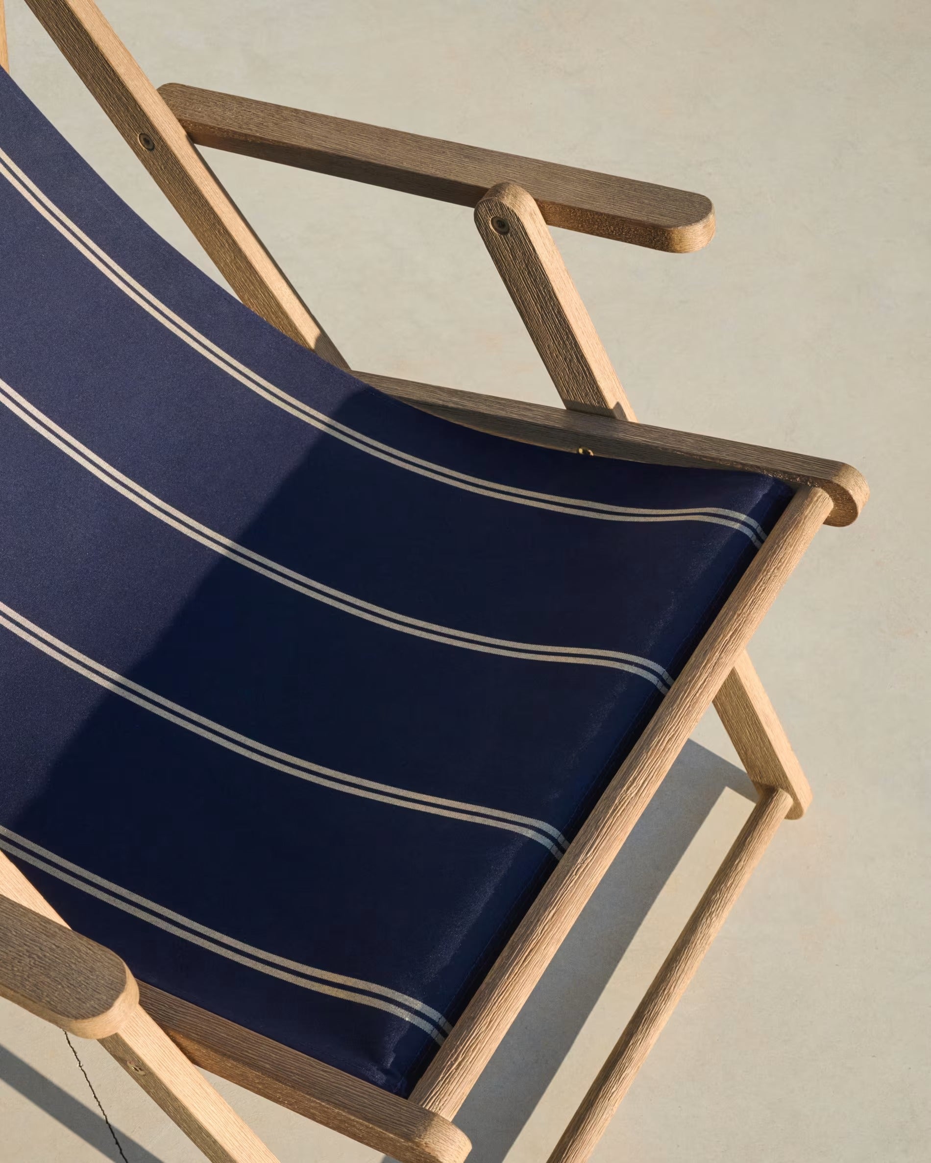 A navy-beige Vilara deckchair with an acacia base