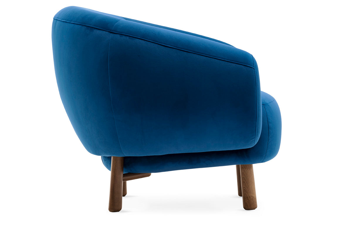 Upholstered RIO armchair with a dark wooden base