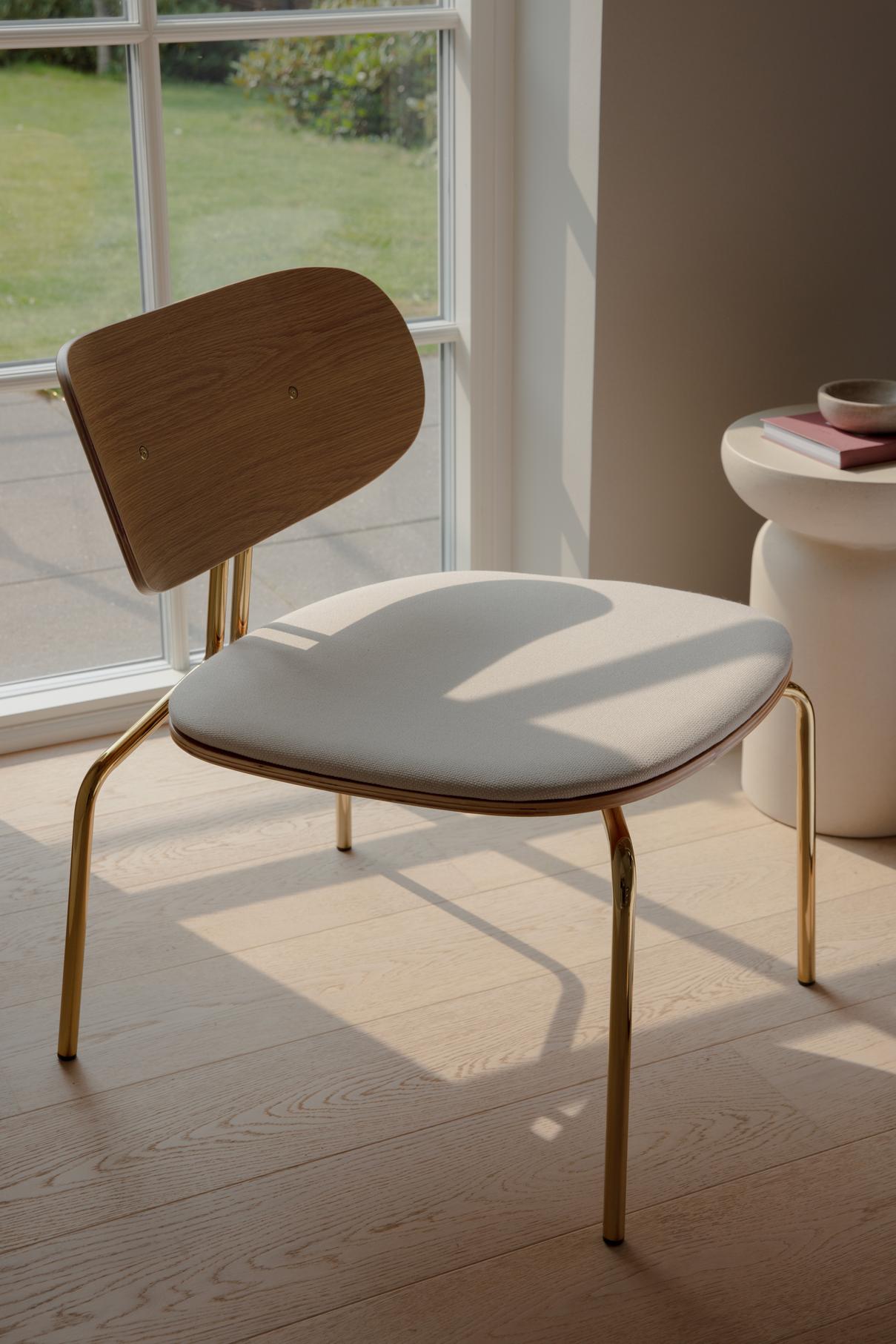 Black beige curious armchair with a black base