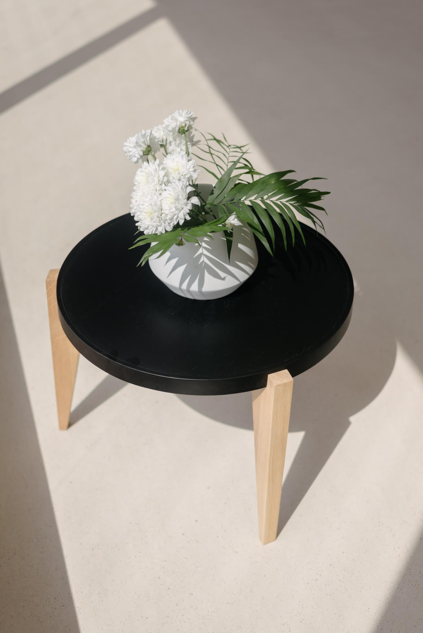 BONTRI table with black top and wooden base